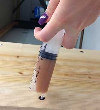 Injecting resin through a Timber Injjector using a sysringe